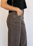 Woman wearing the Colette Wide Leg Jeans in Rebel Cat, brown and charcoal leopard print mid-rise jeans