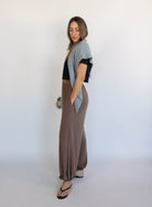 Woman wearing the Wrenley Warm Shawl Scarf in Grey, a heathered grey knit triangle shawl