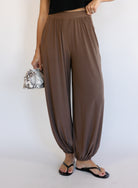 Woman wearing the Rome Relaxed Fit Balloon Pants in Coffee, brown high-rise pull-on balloon pants