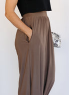 Woman wearing the Rome Relaxed Fit Balloon Pants in Coffee, brown high-rise pull-on balloon pants