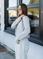 Woman wearing the Cova Cardigan, a grey cropped cotton-wool crewneck cardigan