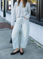 Woman wearing the Cova Cardigan, a grey cropped cotton-wool crewneck cardigan