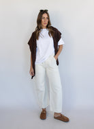 Woman wearing Favorite Daughter The Major Pant, winter white mid-rise barrel-leg cotton pants
