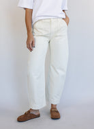 Woman wearing Favorite Daughter The Major Pant, winter white mid-rise barrel-leg cotton pants