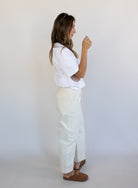 Woman wearing Favorite Daughter The Major Pant, winter white mid-rise barrel-leg cotton pants