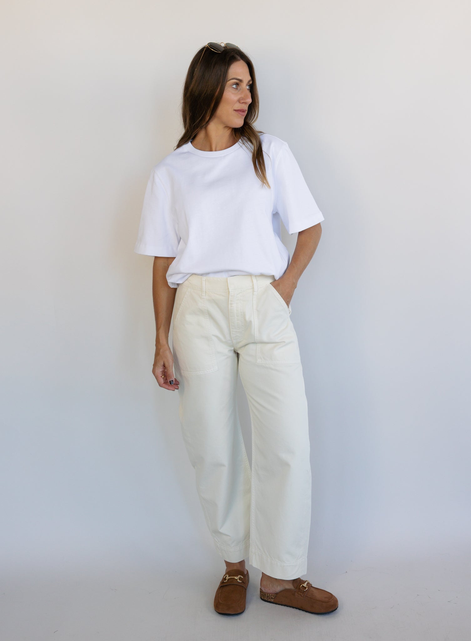 Woman wearing Favorite Daughter The Major Pant, winter white mid-rise barrel-leg cotton pants