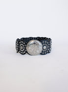 Greta Wide Western Belt in Black, a wide black disc belt with silver grommets and a concho buckle