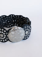 Greta Wide Western Belt in Black, a wide black disc belt with silver grommets and a concho buckle
