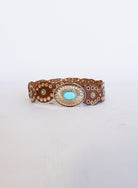 Mirabel Turquoise Disc Belt, a tan disc belt with silver grommets and a turquoise-tone buckle