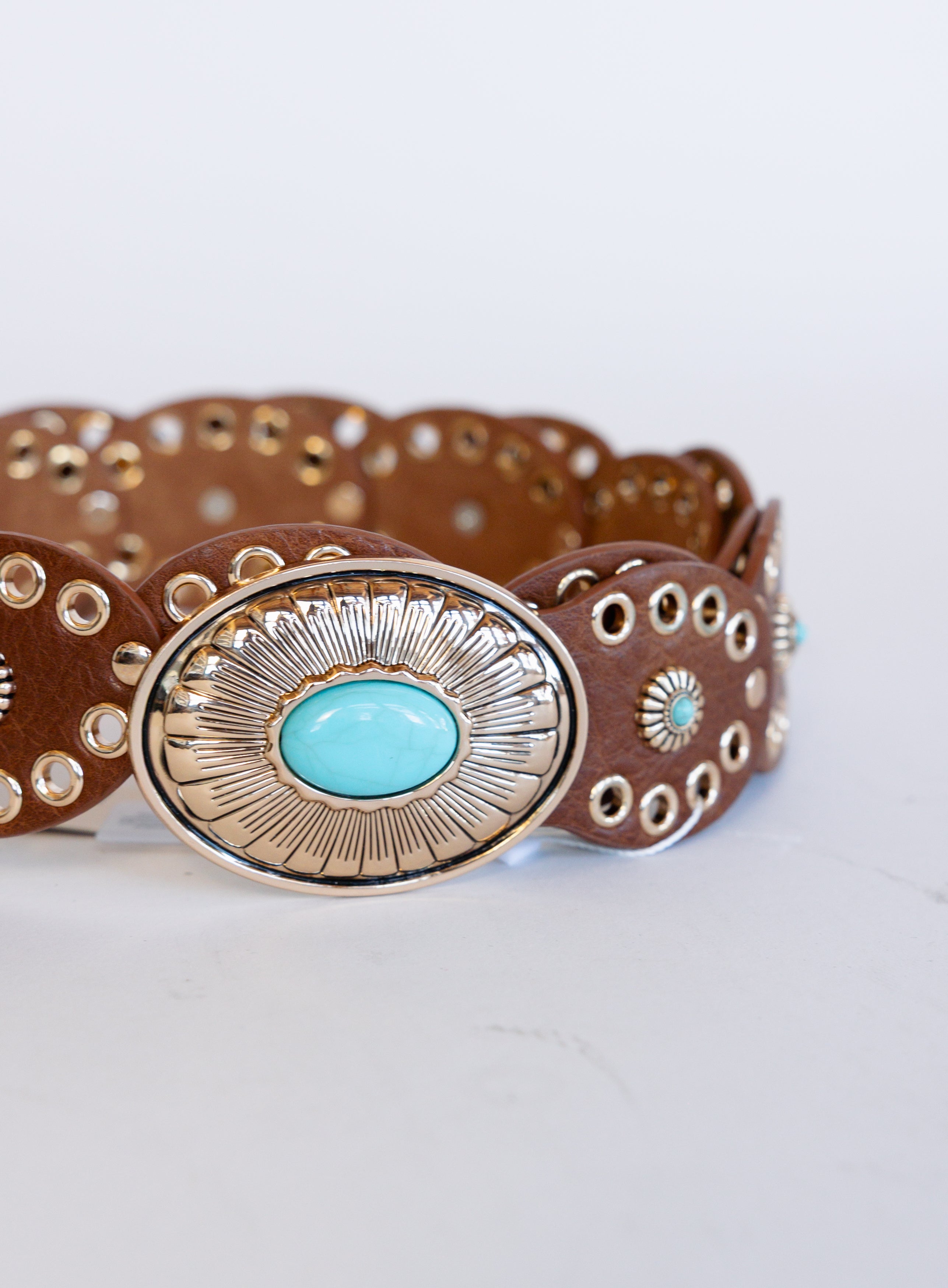 Mirabel Turquoise Disc Belt, a tan disc belt with silver grommets and a turquoise-tone buckle