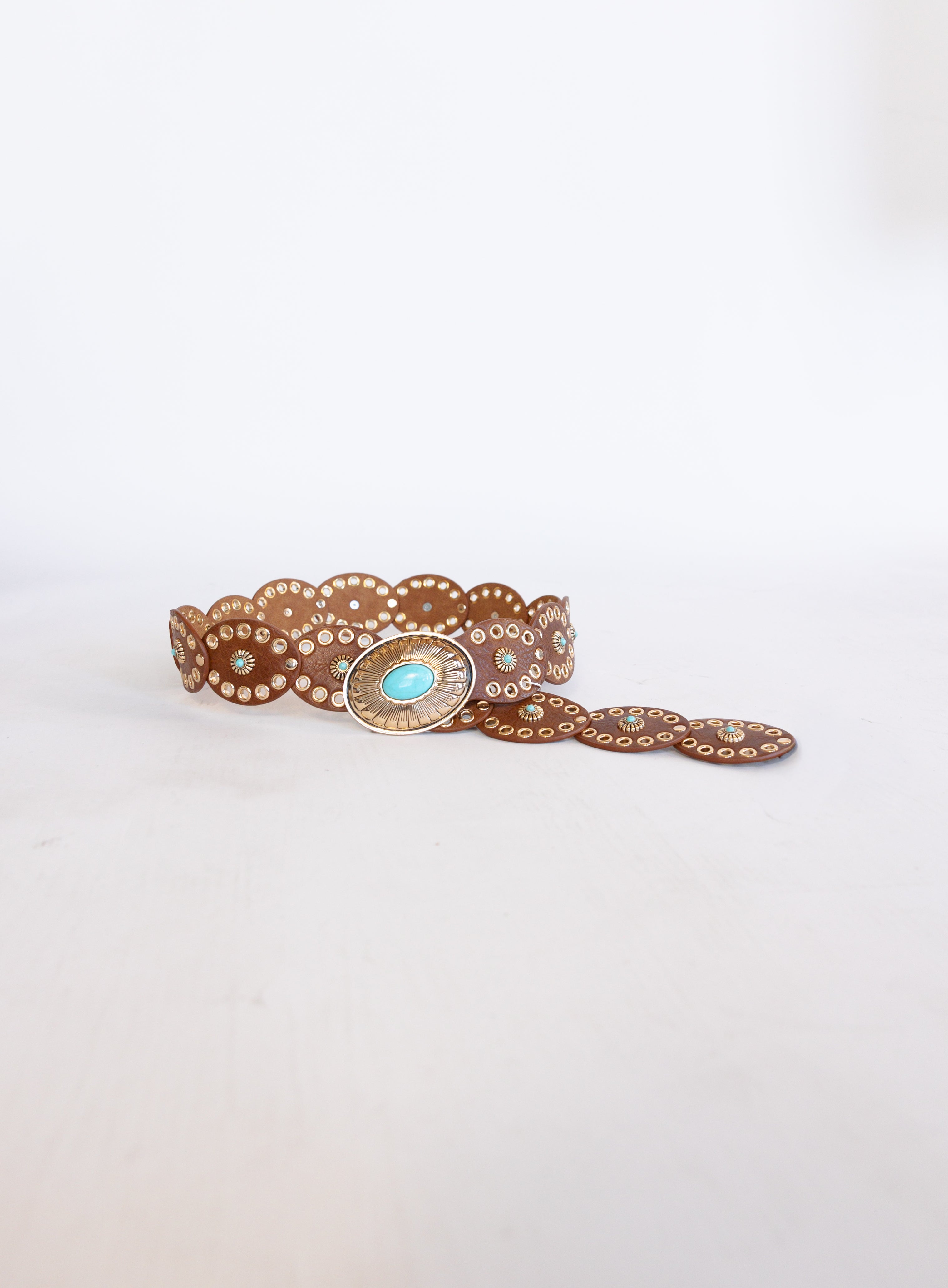 Mirabel Turquoise Disc Belt, a tan disc belt with silver grommets and a turquoise-tone buckle