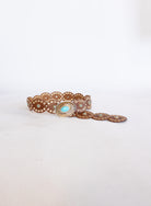 Mirabel Turquoise Disc Belt, a tan disc belt with silver grommets and a turquoise-tone buckle