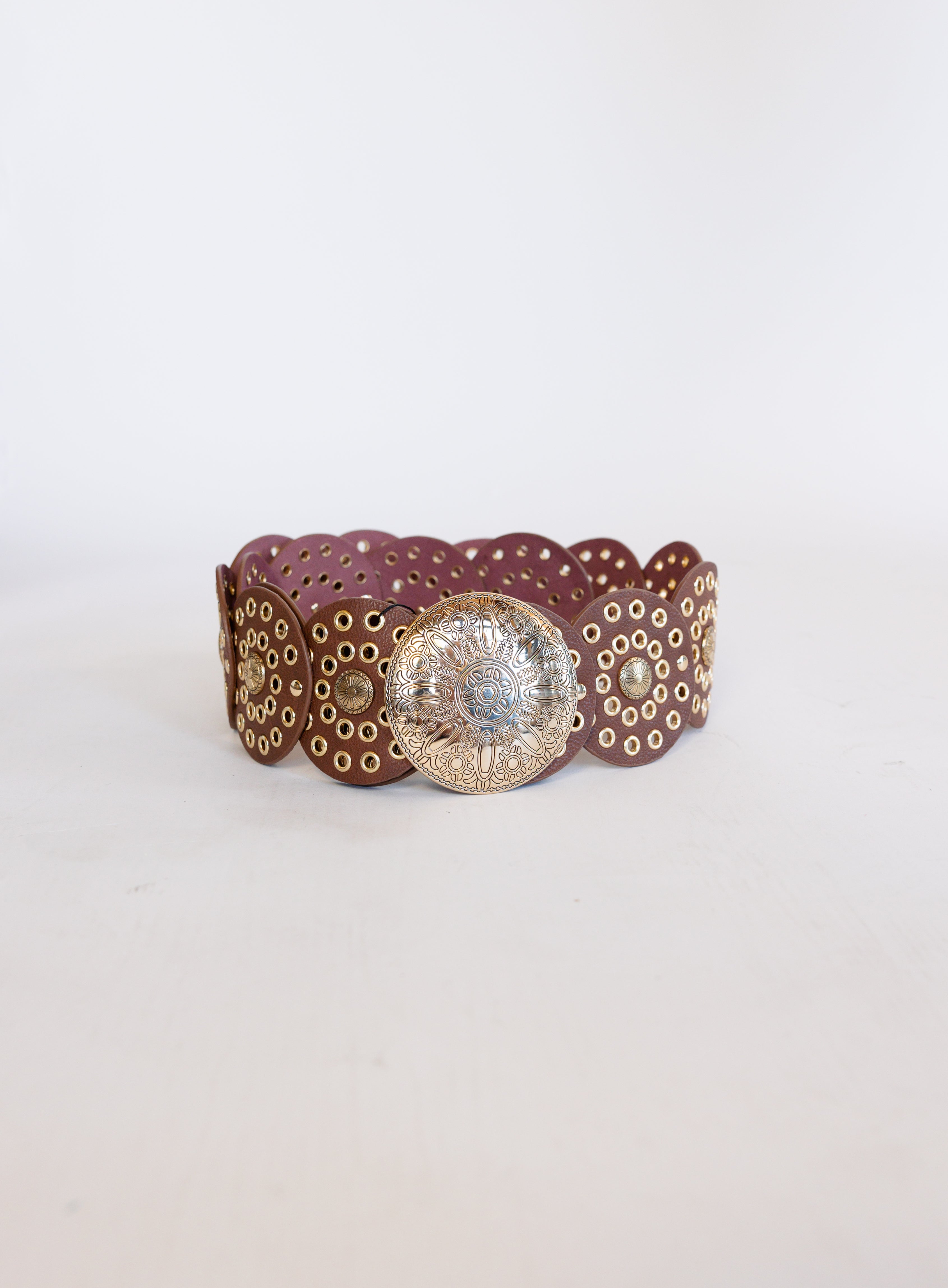 Greta Wide Western Belt in Cognac, a wide cognac disc belt with silver grommets and a concho buckle