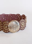 Greta Wide Western Belt in Cognac, a wide cognac disc belt with silver grommets and a concho buckle