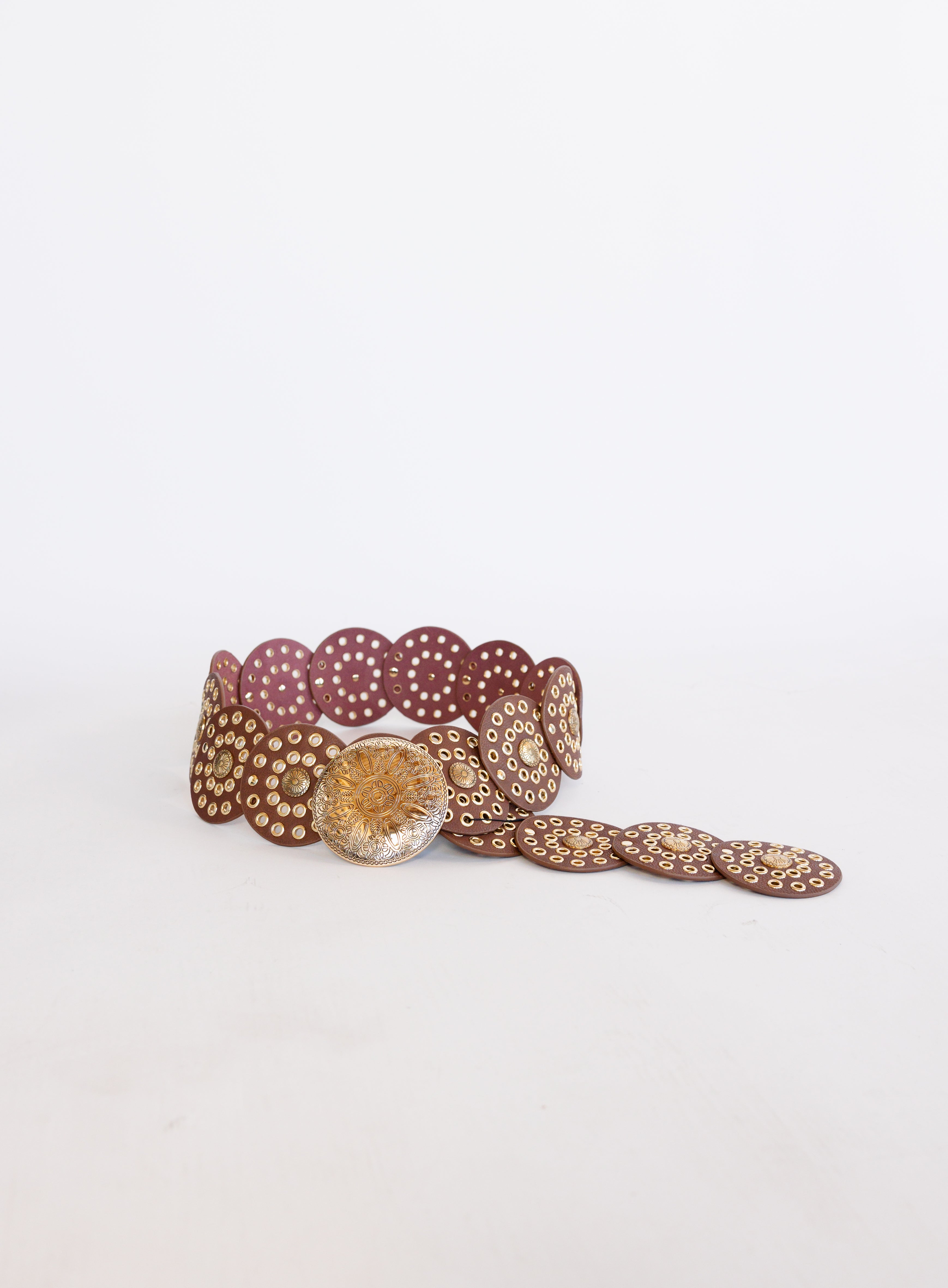 Greta Wide Western Belt in Cognac, a wide cognac disc belt with silver grommets and a concho buckle