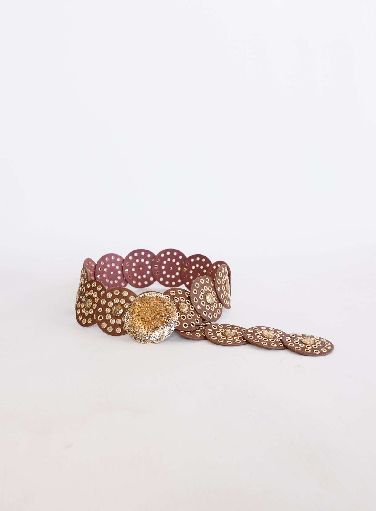 Greta Wide Western Belt in Cognac, a wide cognac disc belt with silver grommets and a concho buckle