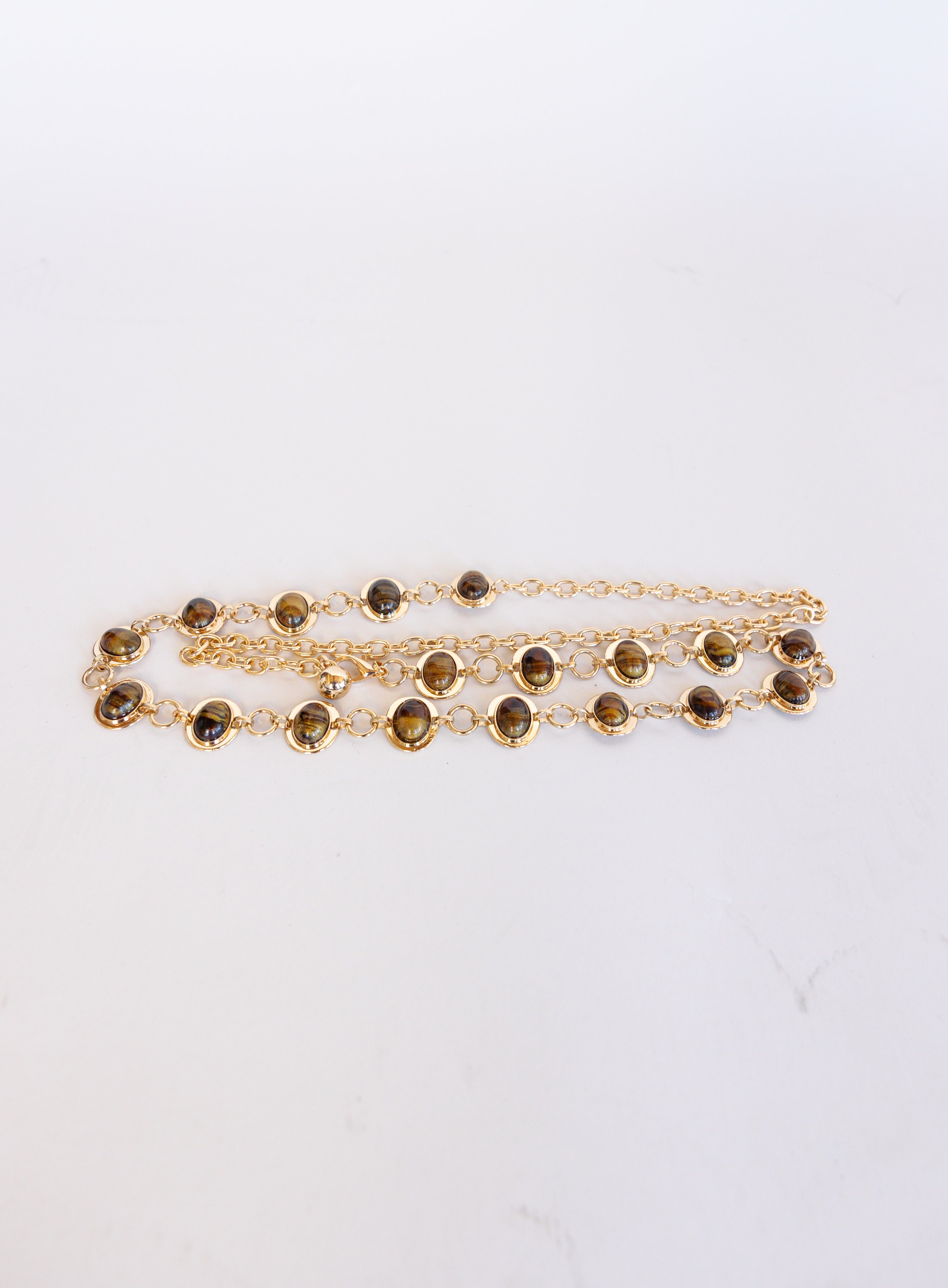 Rosalind Chain Belt, a gold-tone chain belt with glossy tortoise-tone stones