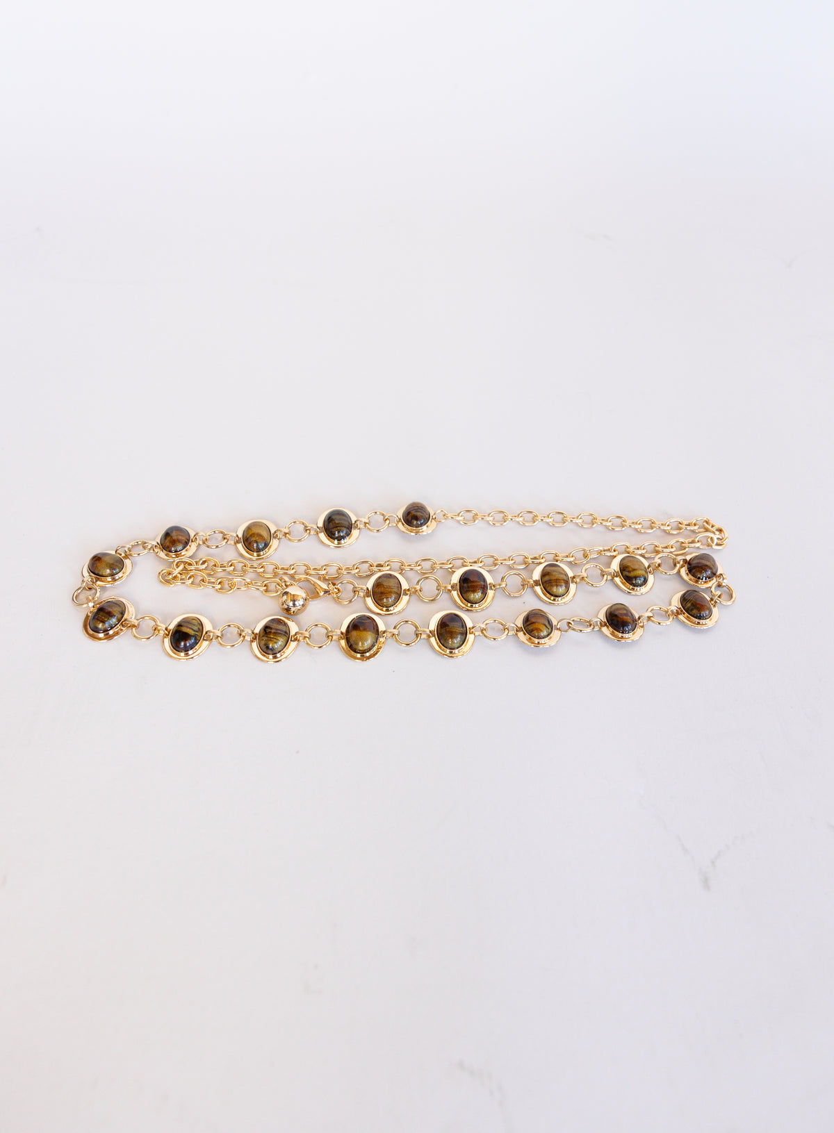 Rosalind Chain Belt, a gold-tone chain belt with glossy tortoise-tone stones
