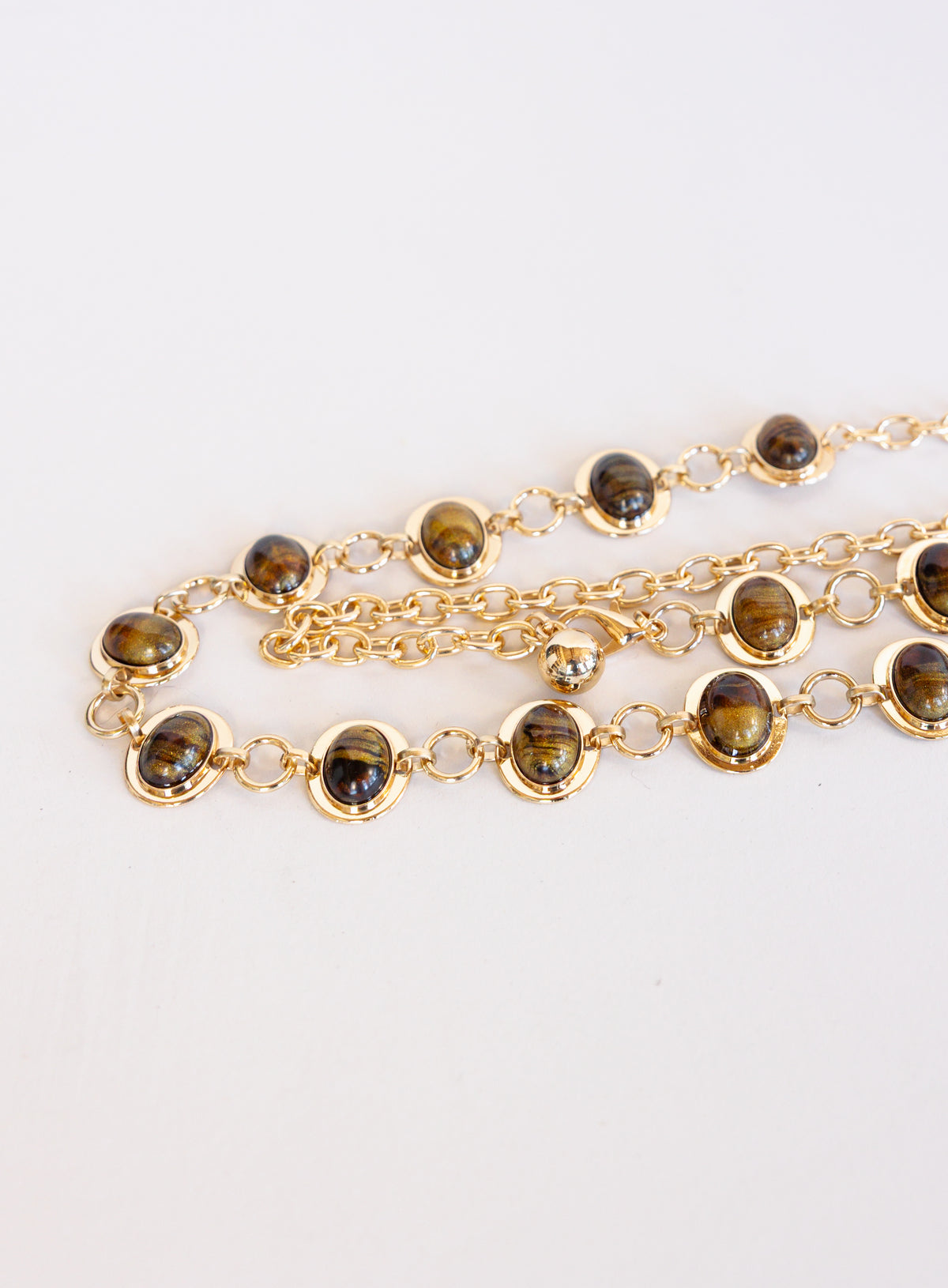 Rosalind Chain Belt, a gold-tone chain belt with glossy tortoise-tone stones