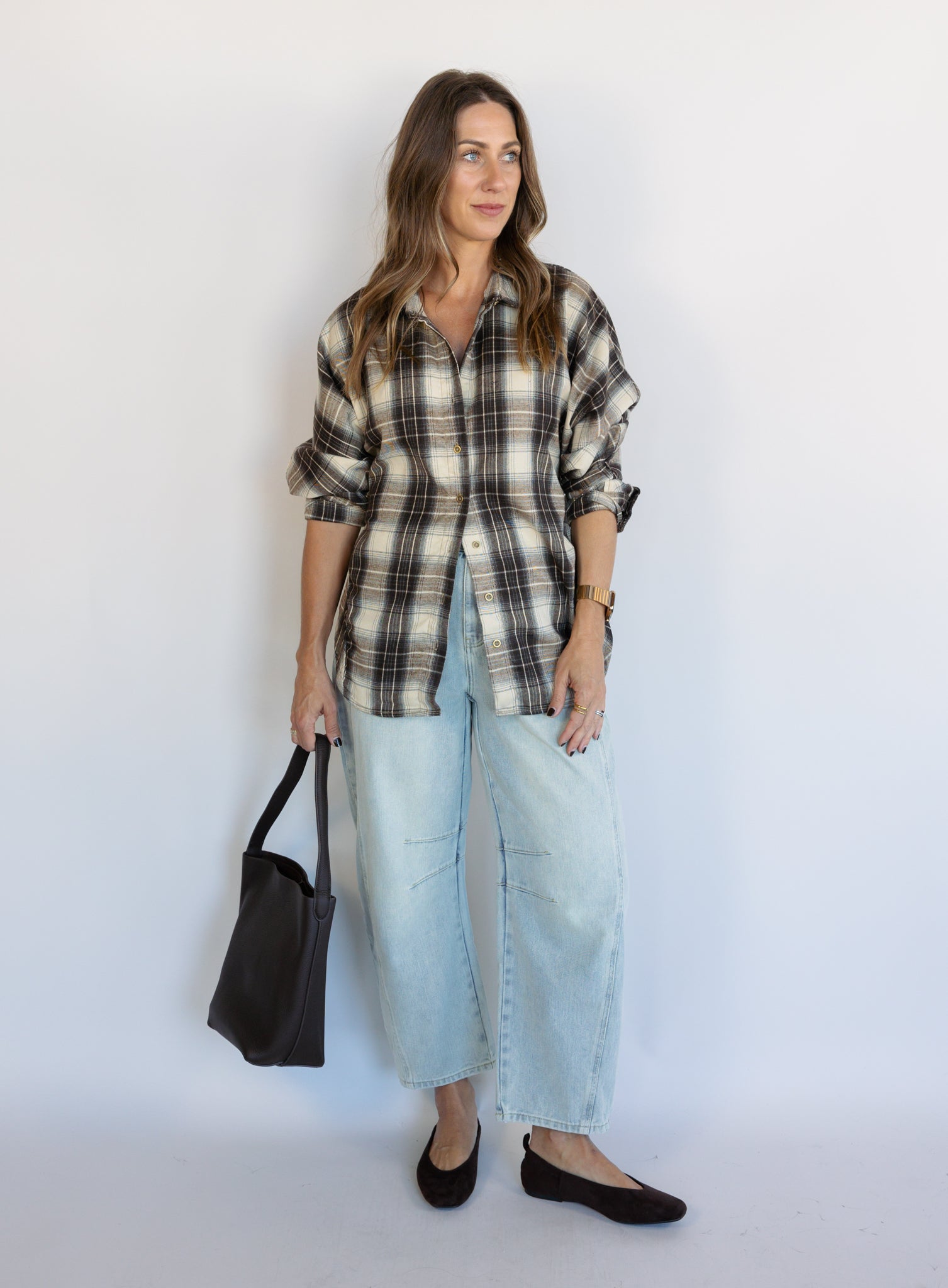 Woman wearing the Poet Barrel Denim Jeans, light-wash high-rise barrel-leg jeans