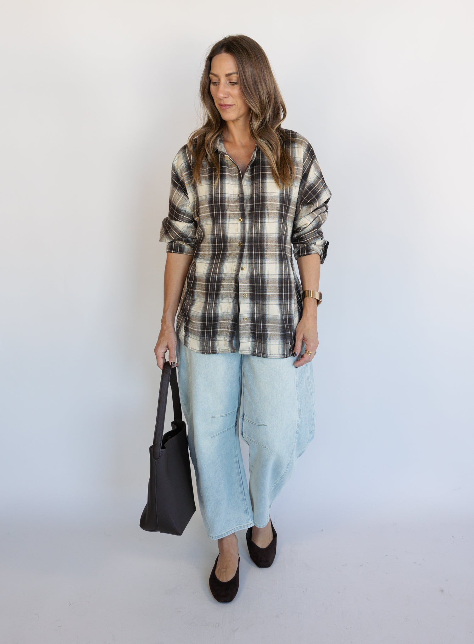 Woman wearing the Poet Barrel Denim Jeans, light-wash high-rise barrel-leg jeans