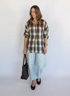 Woman wearing the Poet Barrel Denim Jeans, light-wash high-rise barrel-leg jeans