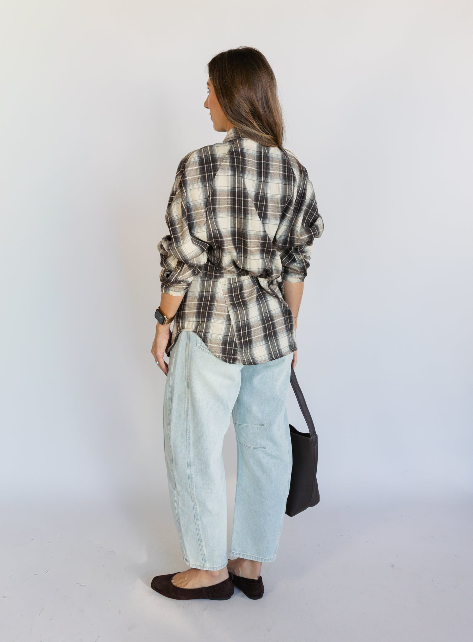 Woman wearing the Poet Barrel Denim Jeans, light-wash high-rise barrel-leg jeans