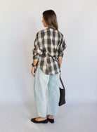 Woman wearing the Poet Barrel Denim Jeans, light-wash high-rise barrel-leg jeans