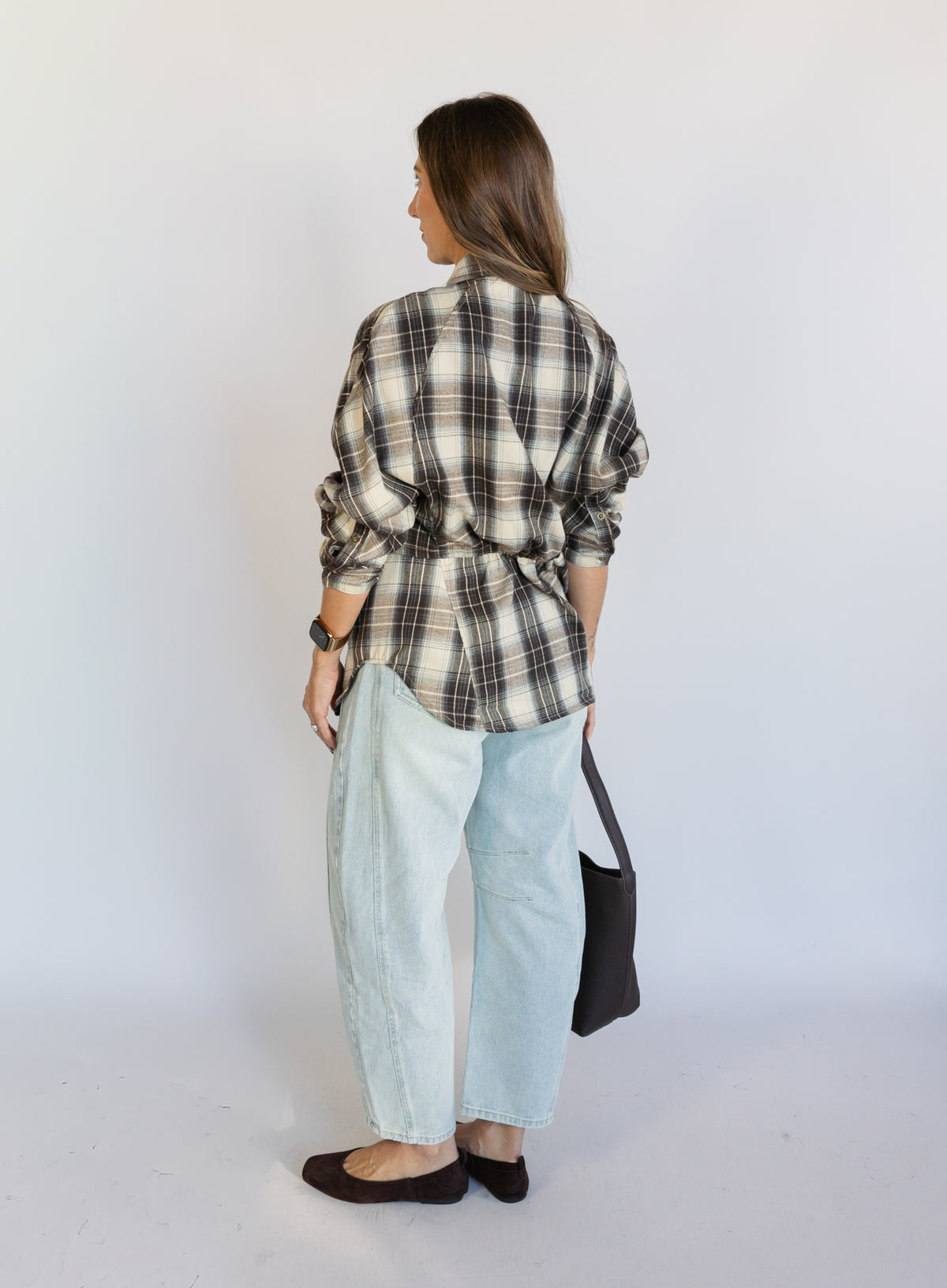 Woman wearing the Poet Barrel Denim Jeans, light-wash high-rise barrel-leg jeans