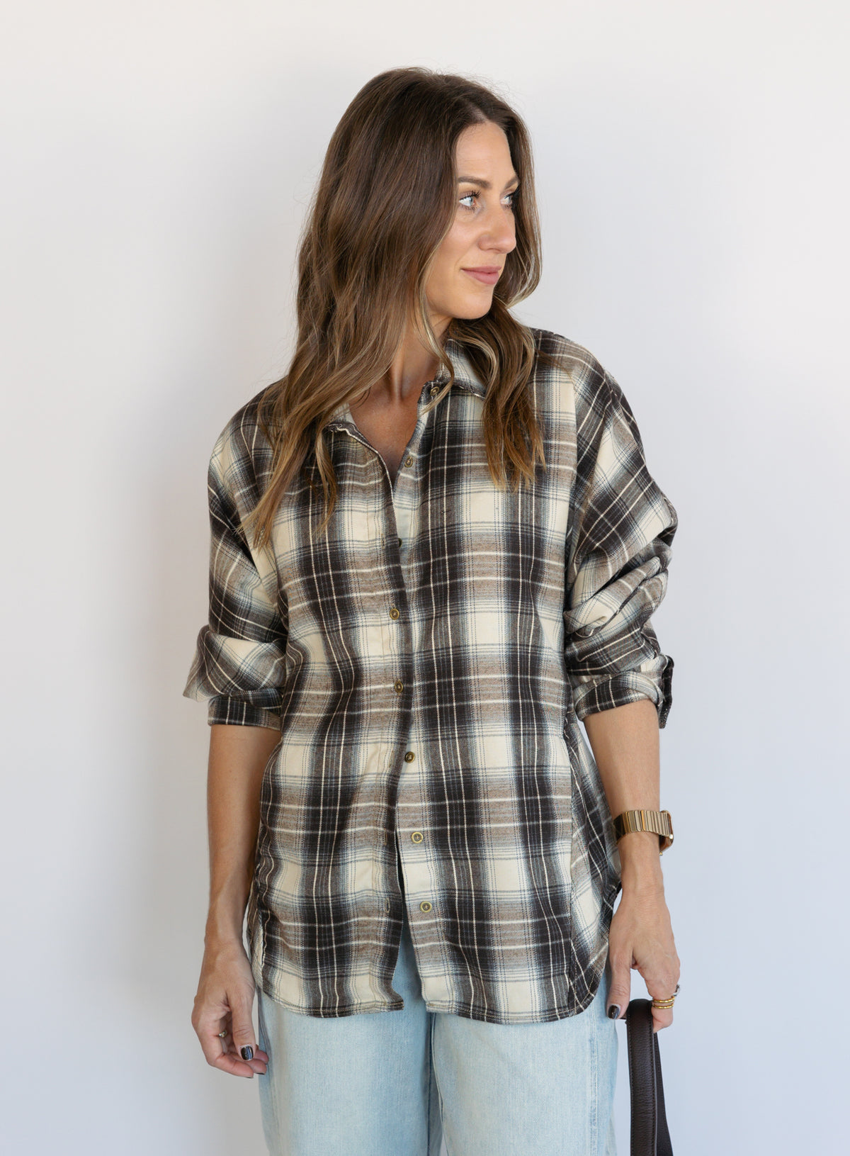 Woman wearing the Heartloom Bobbie Shirt, a black, cream and grey plaid oversized button-down