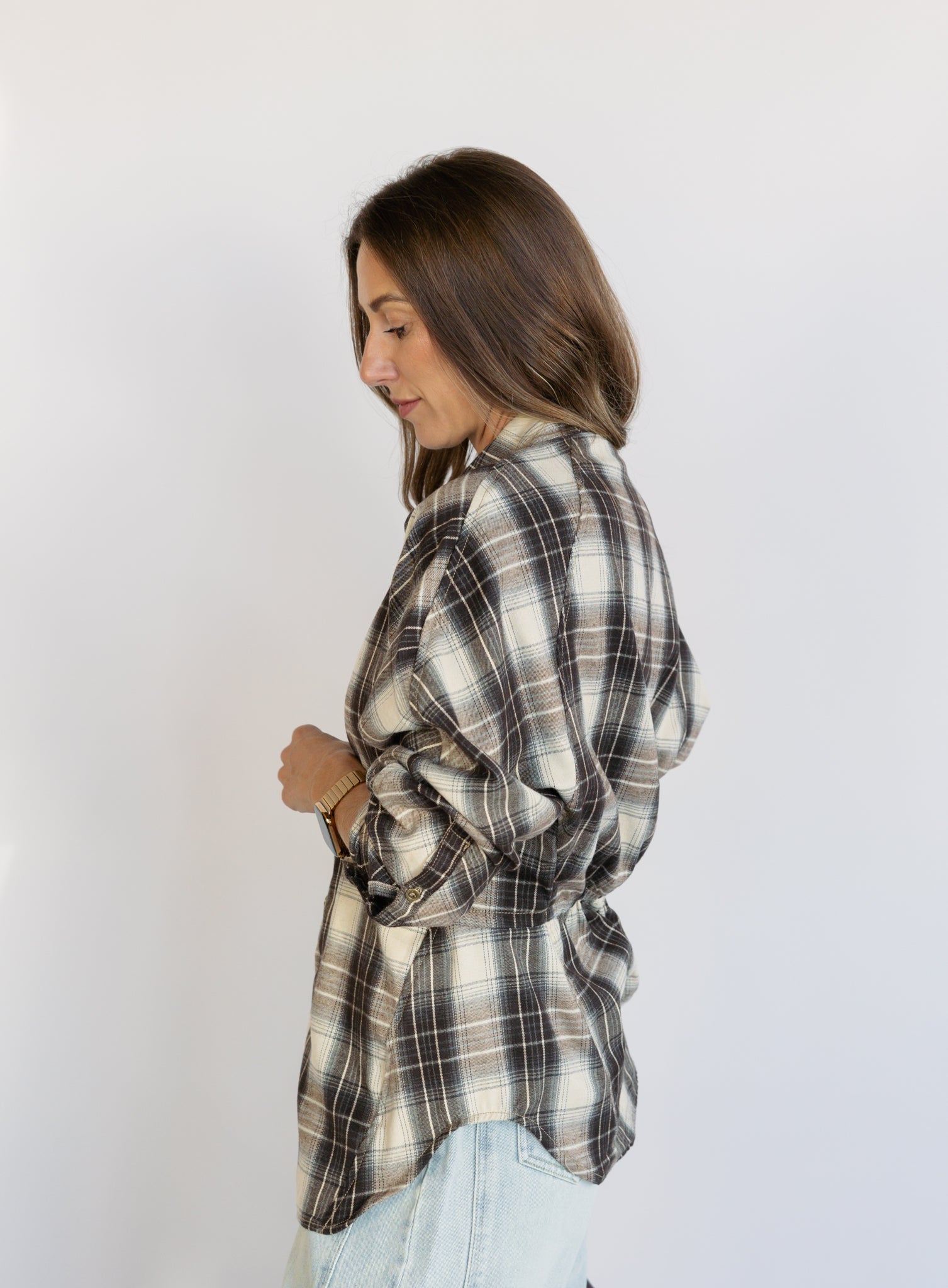 Woman wearing the Heartloom Bobbie Shirt, a black, cream and grey plaid oversized button-down