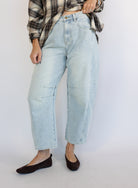 Woman wearing the Poet Barrel Denim Jeans, light-wash high-rise barrel-leg jeans