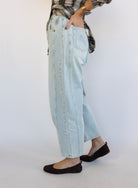 Woman wearing the Poet Barrel Denim Jeans, light-wash high-rise barrel-leg jeans