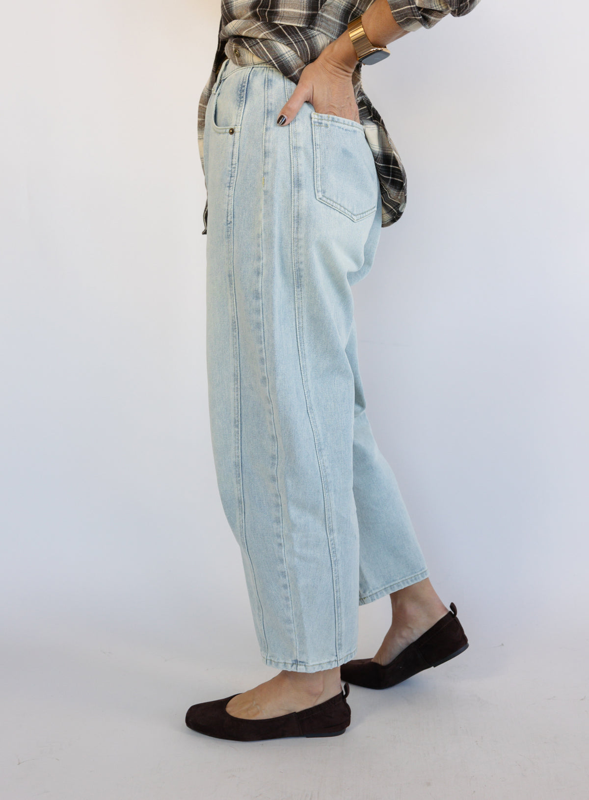 Woman wearing the Poet Barrel Denim Jeans, light-wash high-rise barrel-leg jeans