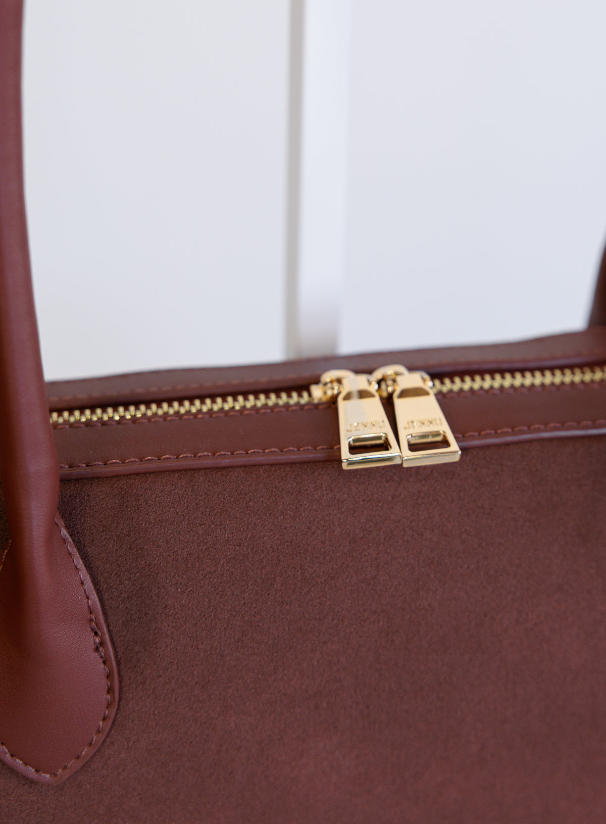Jonava Suede Bag in Garnet, a deep garnet elongated suede shoulder bag with gold zipper pulls