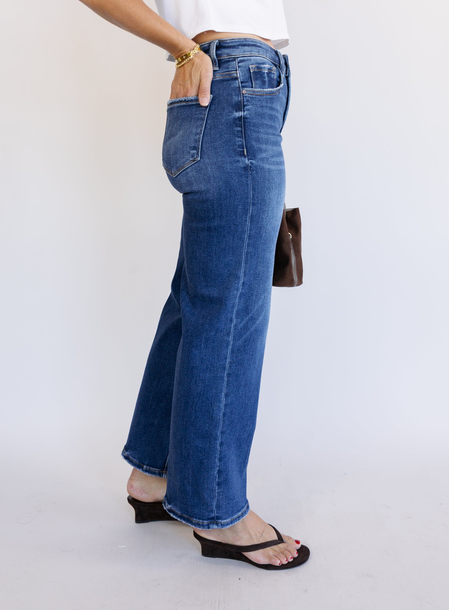 Woman wearing the Jude High Rise Straight Denim, medium blue wash high-rise ankle straight-leg jeans
