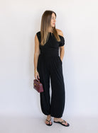 Woman wearing the Azalea Balloon Pants, black lightweight balloon-leg pants with gathered ankle cuffs