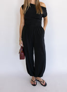 Woman wearing the Azalea Balloon Pants, black lightweight balloon-leg pants with gathered ankle cuffs