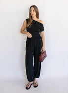 Woman wearing the Azalea Balloon Pants, black lightweight balloon-leg pants with gathered ankle cuffs