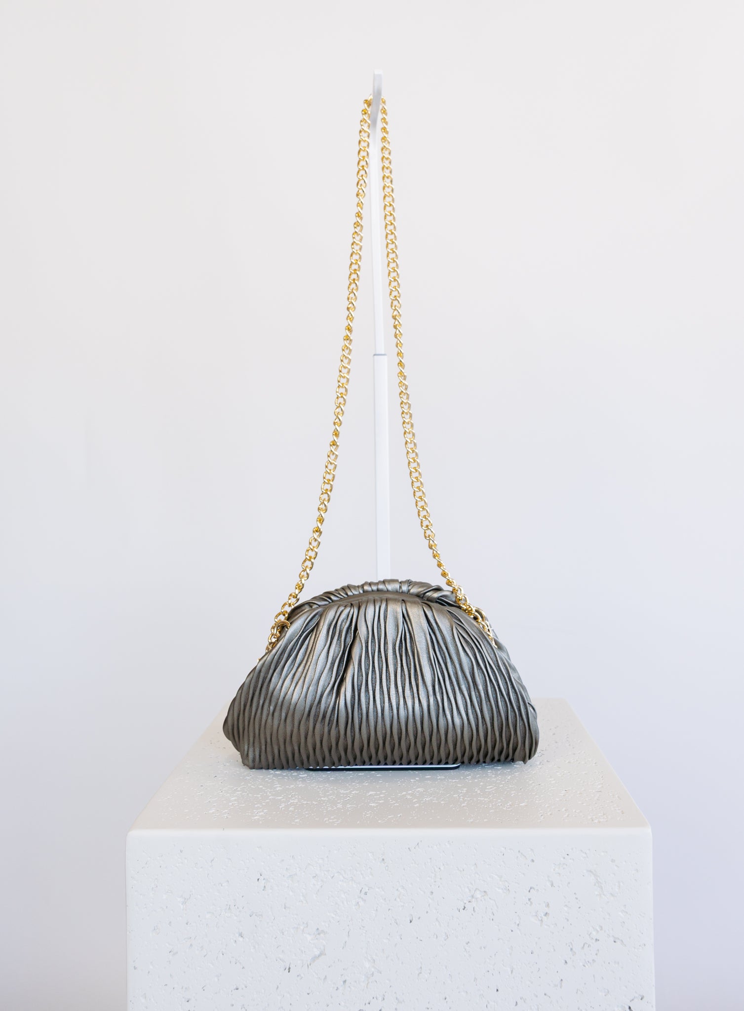 Mallory Clutch, a metallic pewter pleated clutch with a detachable gold chain strap