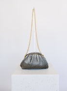 Mallory Clutch, a metallic pewter pleated clutch with a detachable gold chain strap