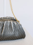 Mallory Clutch, a metallic pewter pleated clutch with a detachable gold chain strap