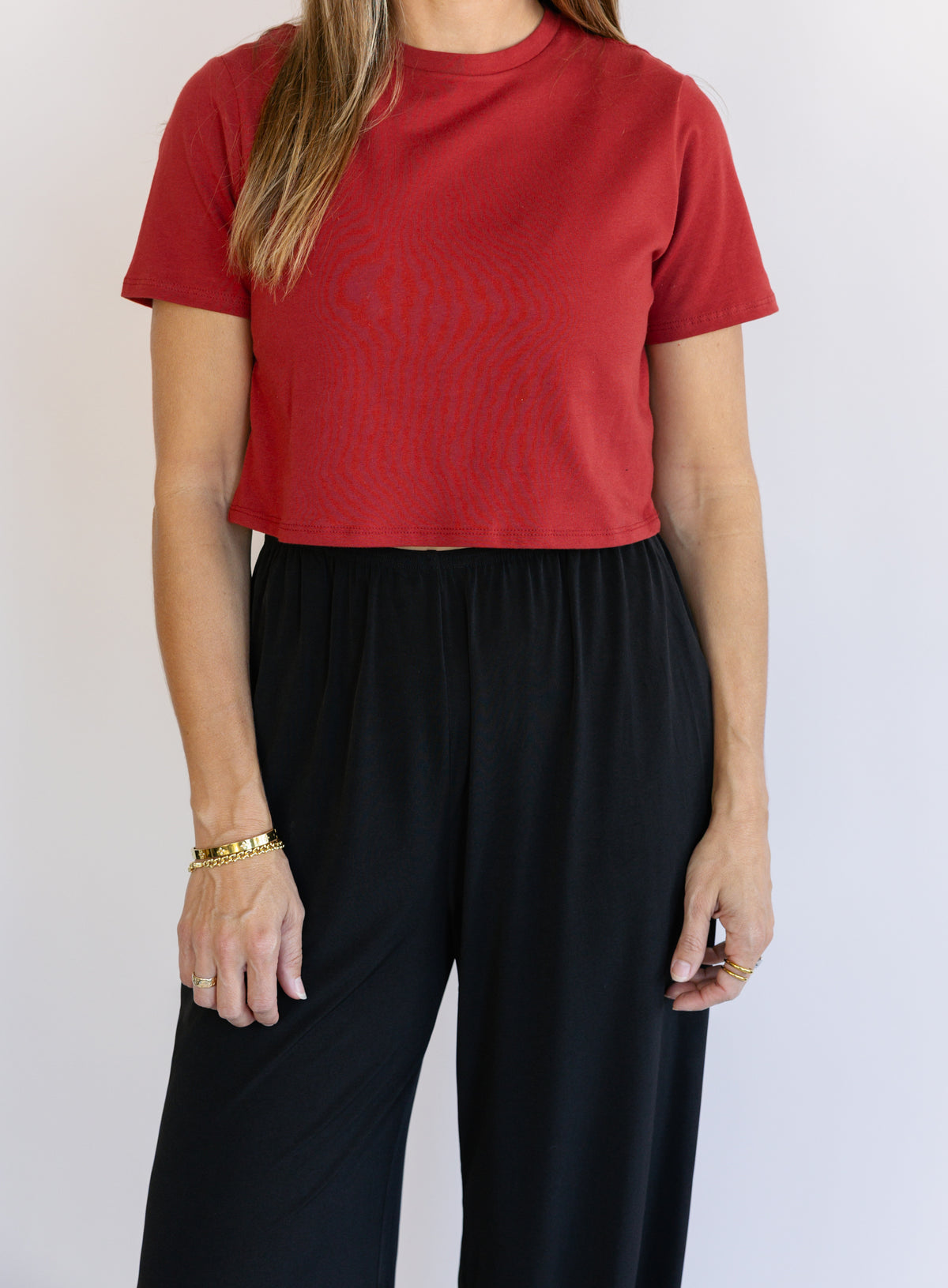 Woman wearing Favorite Daughter The Laura Crop Top in Winery, a fitted cropped crewneck tee