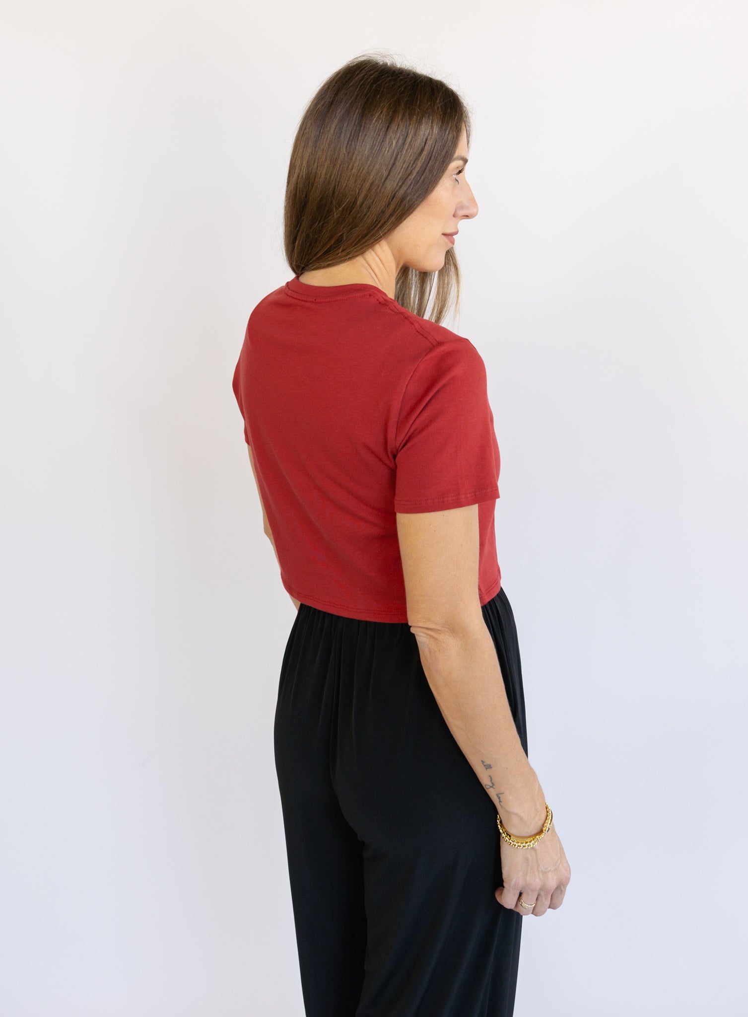 Woman wearing Favorite Daughter The Laura Crop Top in Winery, a fitted cropped crewneck tee