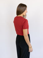 Woman wearing Favorite Daughter The Laura Crop Top in Winery, a fitted cropped crewneck tee