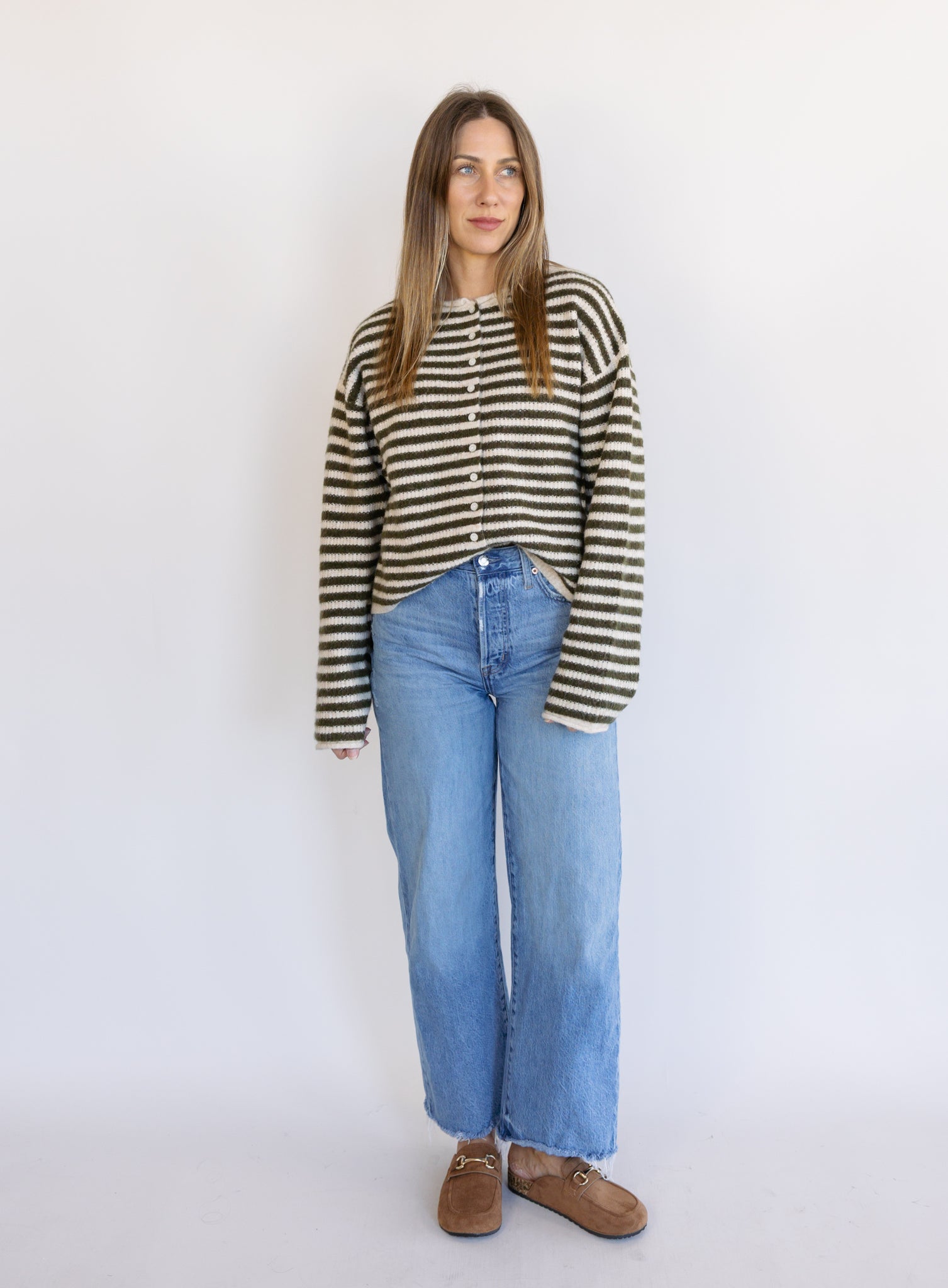 Woman wearing the Marlowe Striped Cardigan, an olive and cream striped button-front cardigan