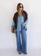 Woman wearing the Ginger Shirt, a light denim wash Tencel button-front chambray shirt