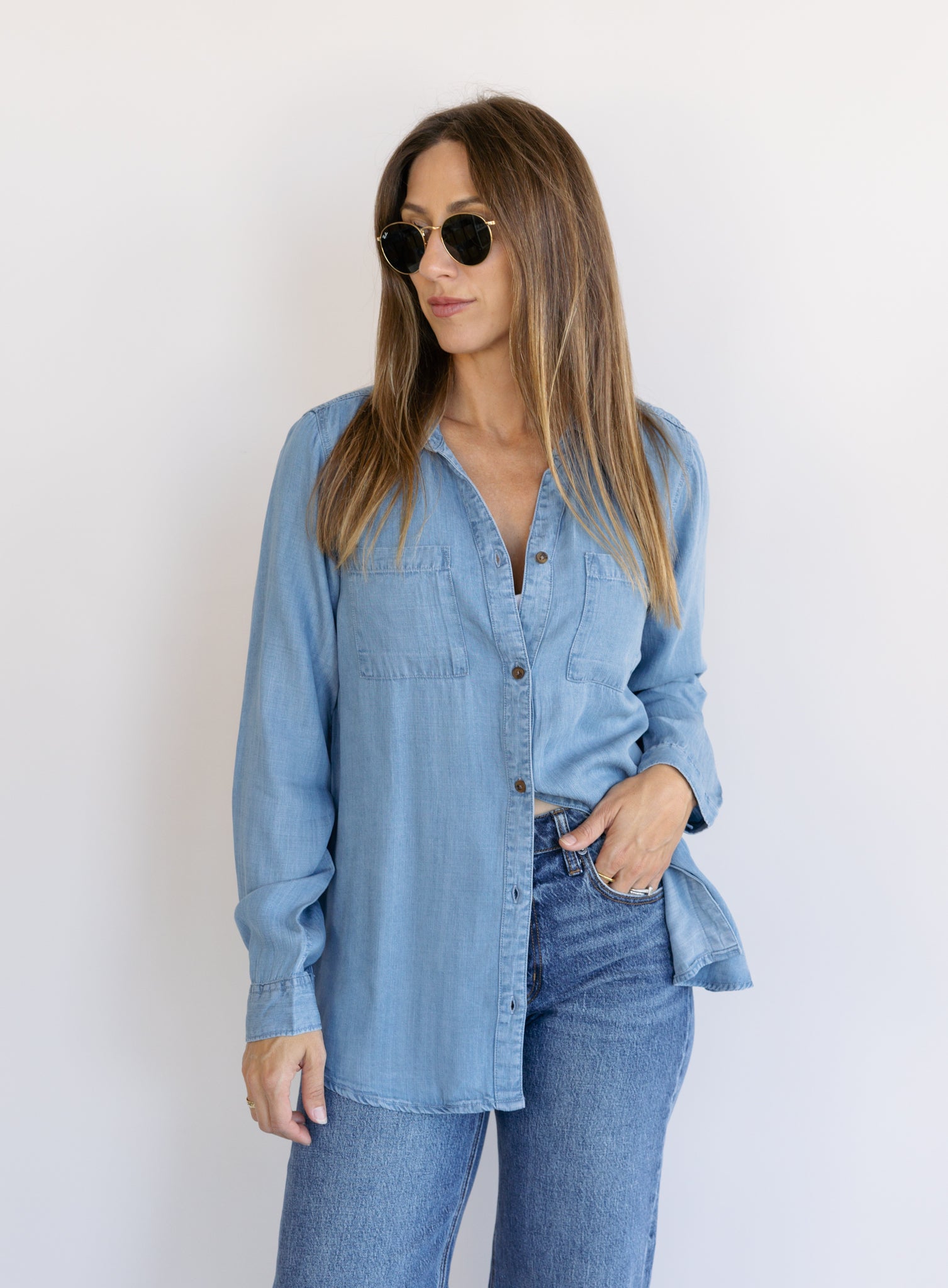Woman wearing the Ginger Shirt, a light denim wash Tencel button-front chambray shirt