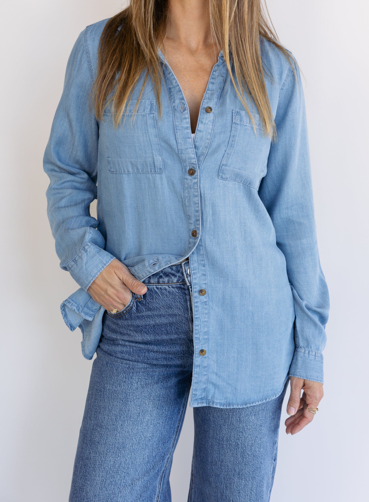 Woman wearing the Ginger Shirt, a light denim wash Tencel button-front chambray shirt
