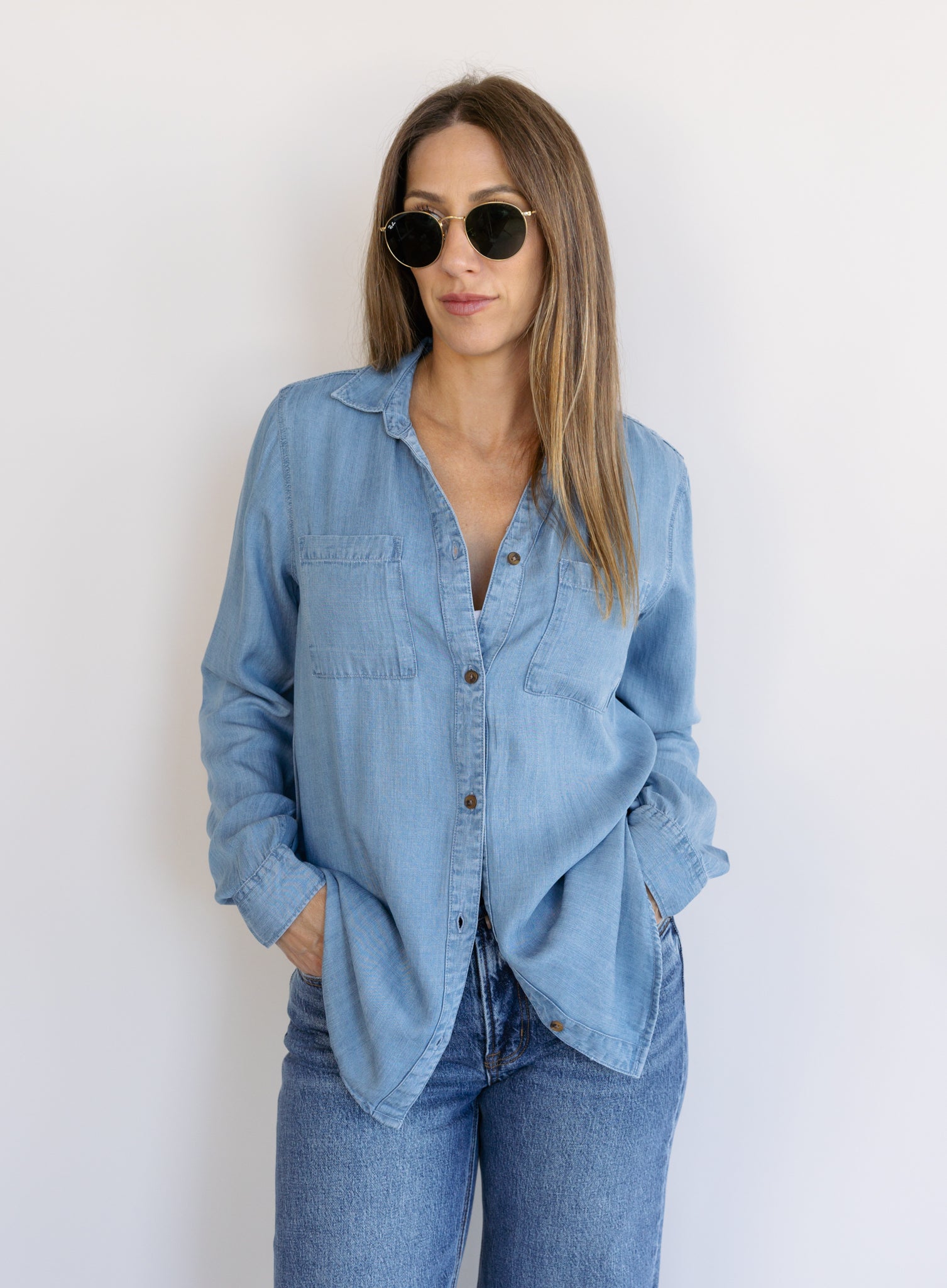 Woman wearing the Ginger Shirt, a light denim wash Tencel button-front chambray shirt